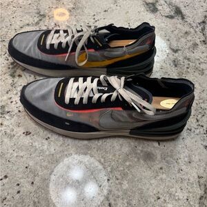 Nike Black and Gray Athletic Shoes with Metallic Gold Swoosh